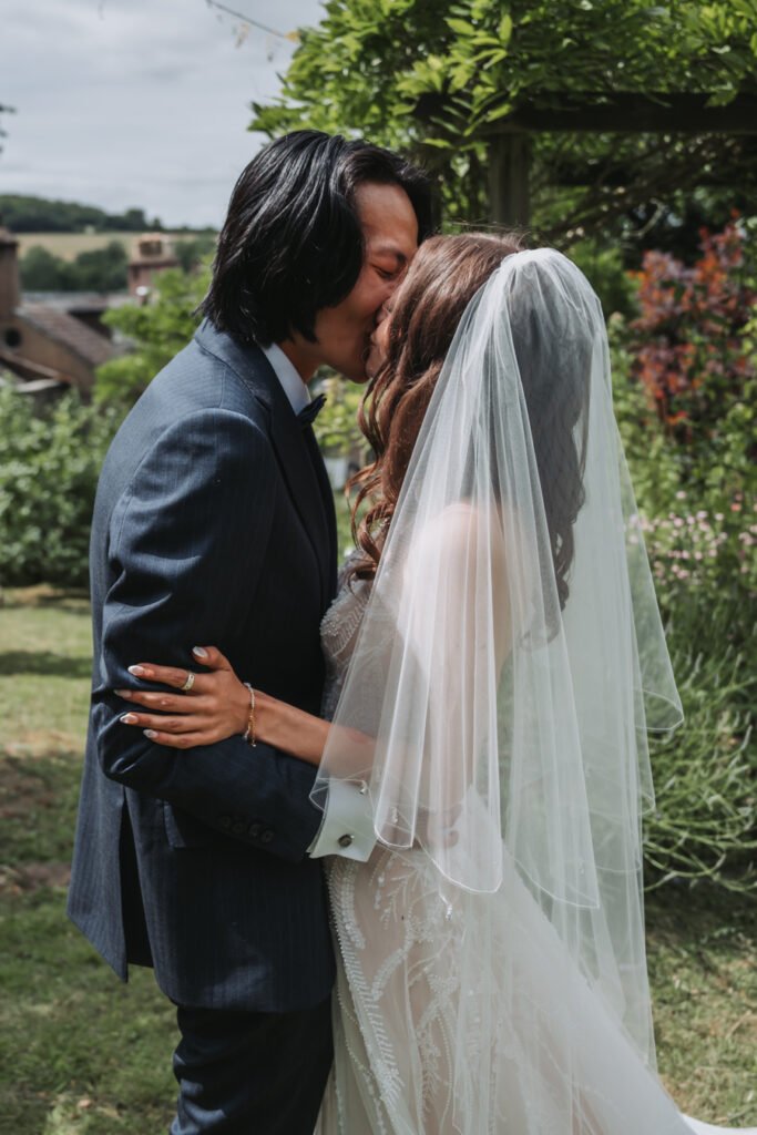 First look in the hidden garden maze by Lost Music Hall destination wedding photographer.
