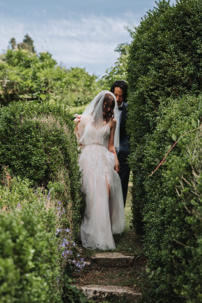First look in the hidden garden maze by Lost Music Hall destination wedding photographer.