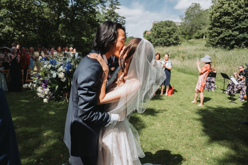 Outdoor wedding ceremony in South Devon field at Lost Music Hall.